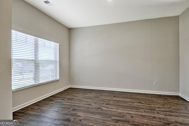 unfurnished room featuring dark hardwood / wood-style flooring