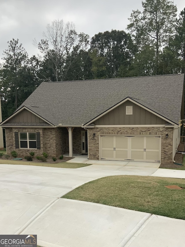 view of front of home with a front lawn and a garage