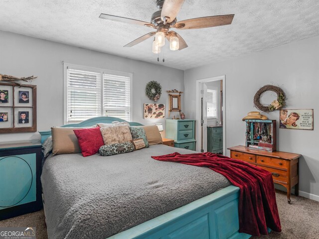 carpeted bedroom with ceiling fan, a textured ceiling, and baseboards