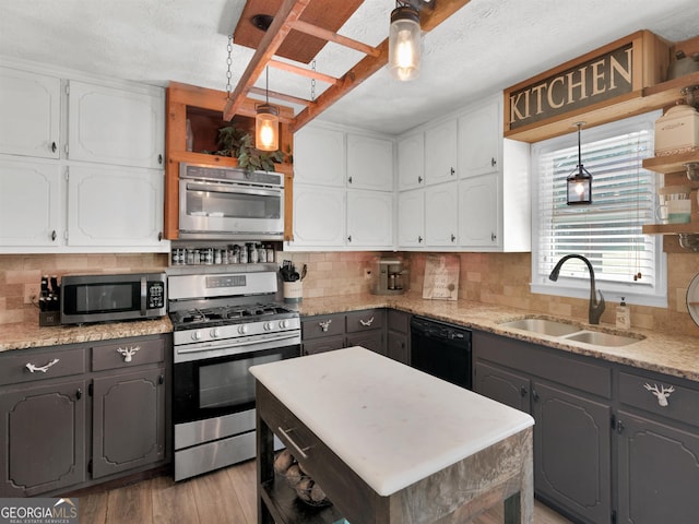 kitchen with open shelves, stainless steel appliances, gray cabinets, white cabinets, and a sink