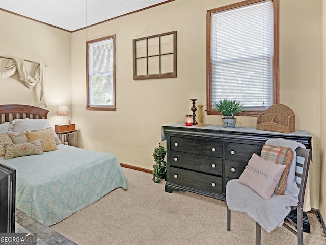 carpeted bedroom with crown molding, multiple windows, and baseboards