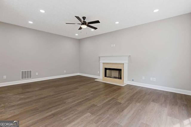 unfurnished living room featuring dark hardwood / wood-style floors and ceiling fan