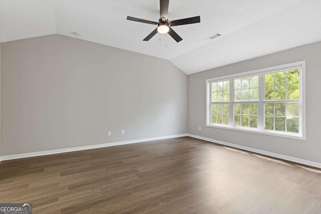 spare room featuring dark hardwood / wood-style flooring, ceiling fan, and lofted ceiling