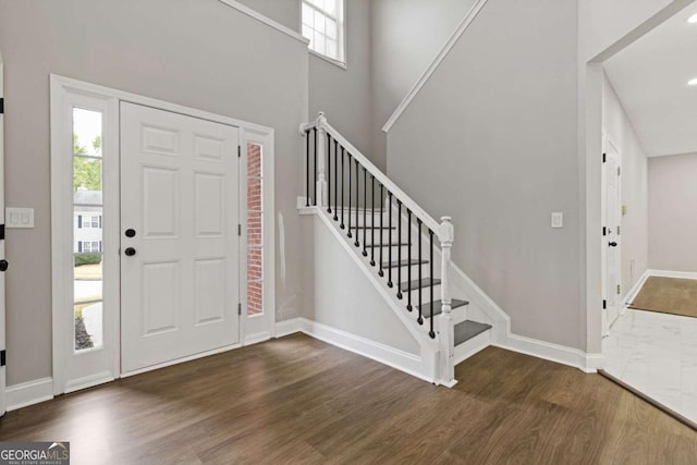 foyer entrance with dark hardwood / wood-style floors