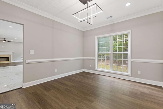 interior space with ceiling fan, dark hardwood / wood-style flooring, ornamental molding, and a textured ceiling