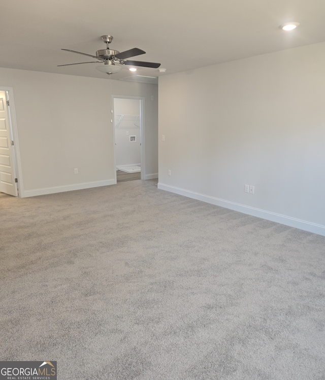 carpeted spare room with ceiling fan, baseboards, and recessed lighting