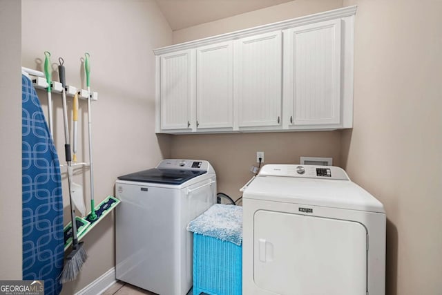 laundry room with cabinets and washer and dryer