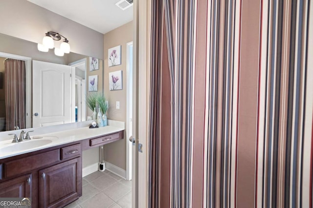 bathroom with tile patterned flooring and vanity