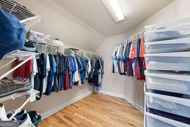 spacious closet with hardwood / wood-style floors and lofted ceiling