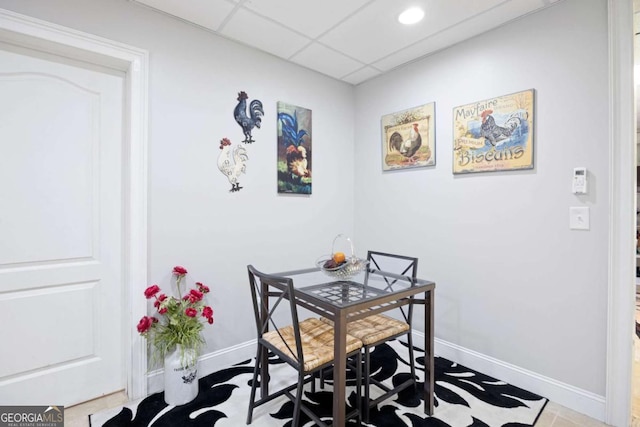 home office featuring a paneled ceiling and tile patterned flooring