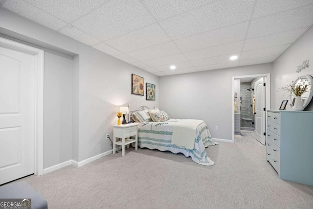 carpeted bedroom featuring a paneled ceiling