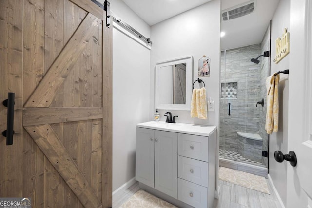 bathroom with vanity and a shower with shower door