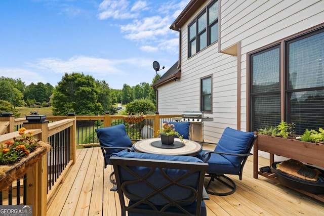 wooden deck featuring area for grilling