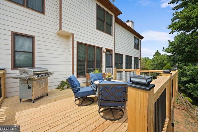 wooden terrace featuring a grill and an outdoor hangout area