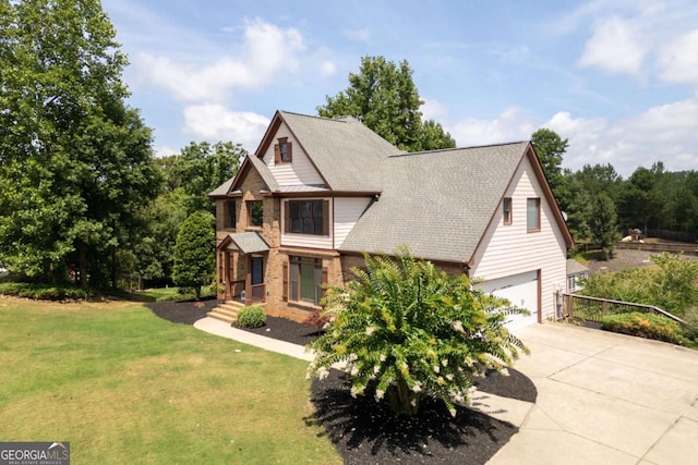 view of front of home featuring a front yard and a garage