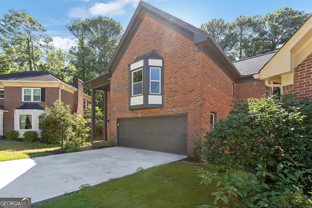 view of home's exterior with a lawn and a garage