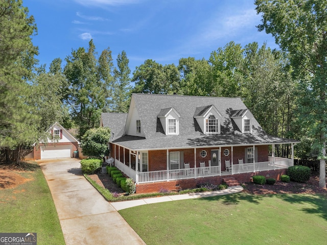 view of front of house featuring a front yard, an outdoor structure, and a garage