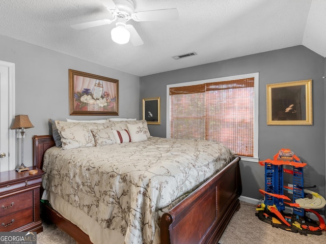 carpeted bedroom with lofted ceiling, ceiling fan, and a textured ceiling