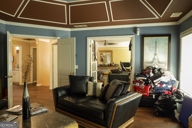 home theater with dark hardwood / wood-style flooring and ornamental molding