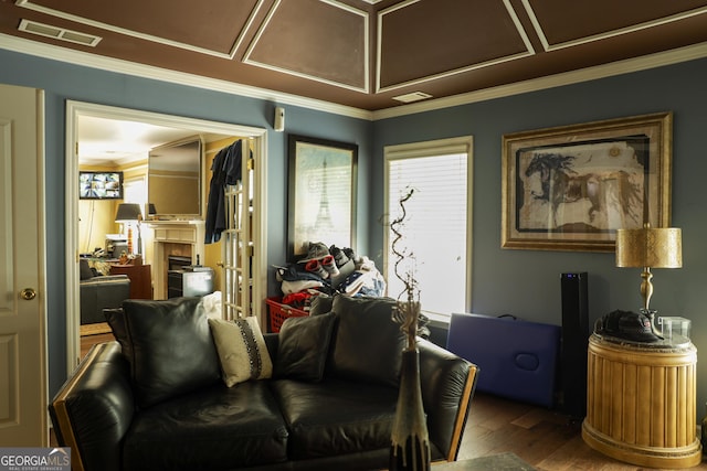 living room with hardwood / wood-style floors and crown molding