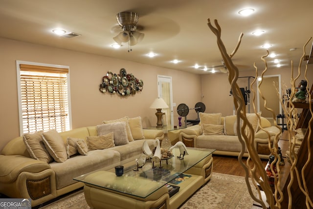 living room featuring ceiling fan and light hardwood / wood-style flooring