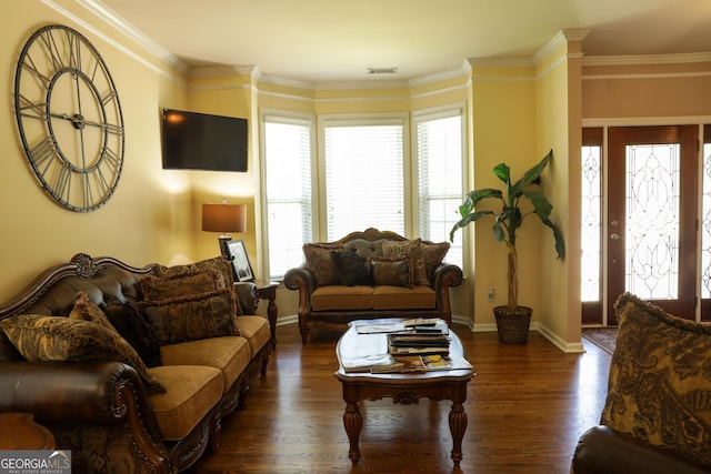 living room with dark hardwood / wood-style floors, crown molding, and a wealth of natural light