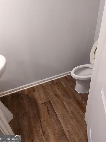 bathroom with hardwood / wood-style floors and toilet