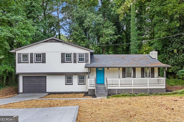 split level home with covered porch and a garage