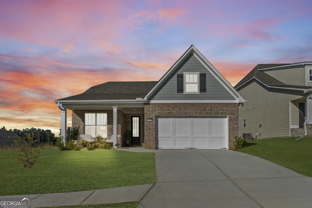 view of front of home with a lawn, cooling unit, and a garage