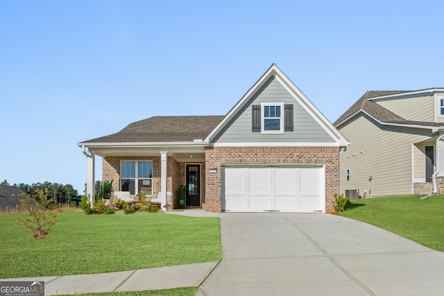 craftsman house featuring a garage, a front yard, and central AC