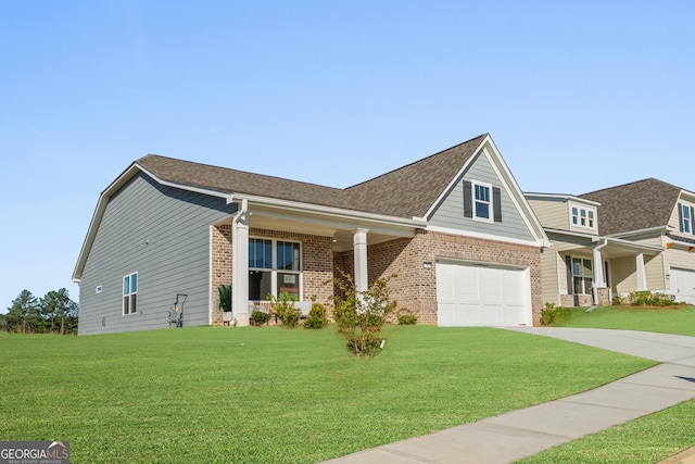 craftsman inspired home with a garage and a front lawn