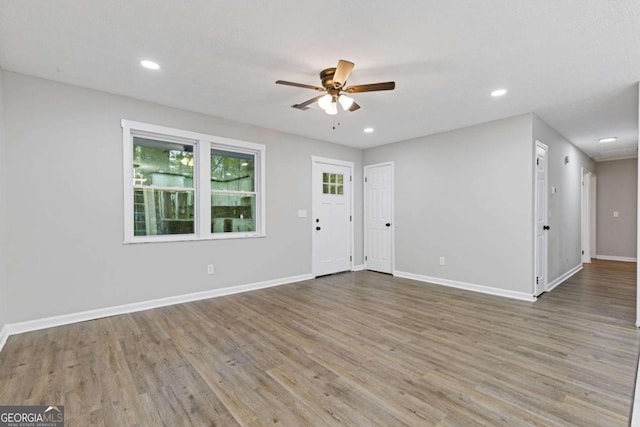 interior space featuring wood-type flooring and ceiling fan