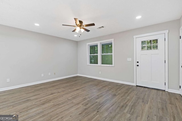 foyer entrance featuring ceiling fan and dark wood-type flooring