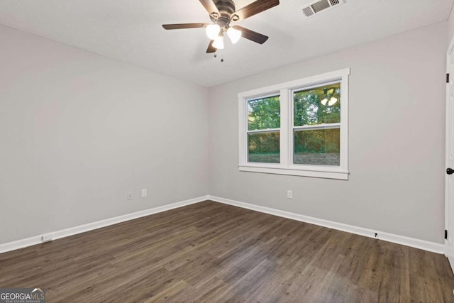 empty room featuring ceiling fan and dark hardwood / wood-style floors