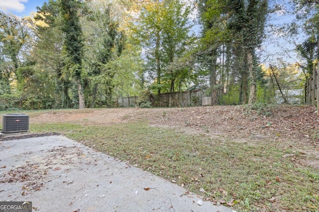 view of yard with a patio and central air condition unit