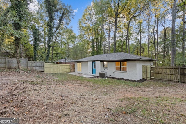 rear view of property featuring cooling unit