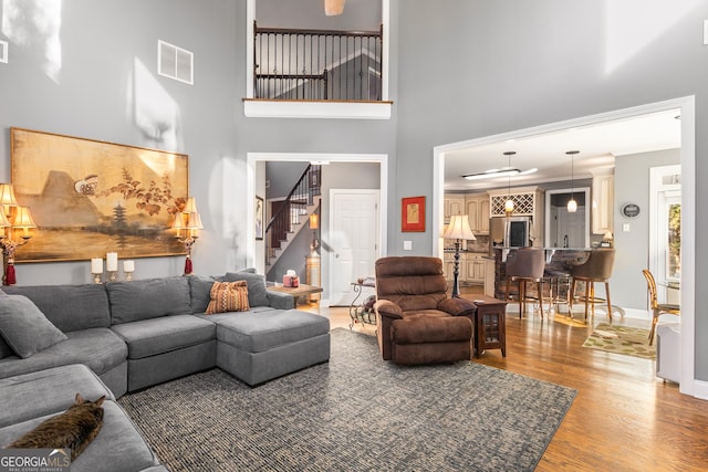 living room featuring hardwood / wood-style floors and a high ceiling