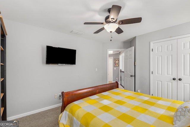 bedroom featuring ceiling fan, a closet, and carpet floors