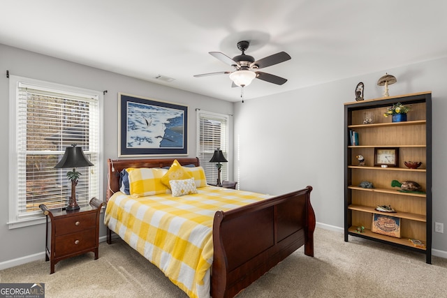 bedroom with multiple windows, ceiling fan, and carpet floors