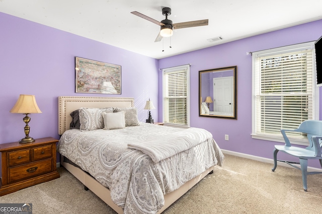 bedroom featuring light carpet and ceiling fan