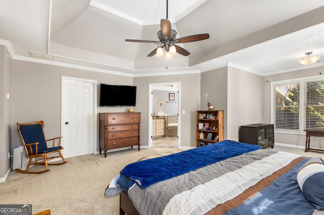 carpeted bedroom with ensuite bath, a raised ceiling, ceiling fan, and crown molding