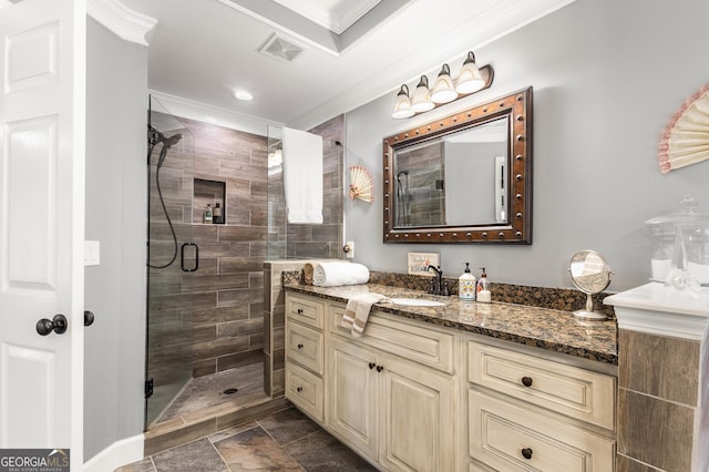 bathroom featuring vanity, an enclosed shower, and crown molding