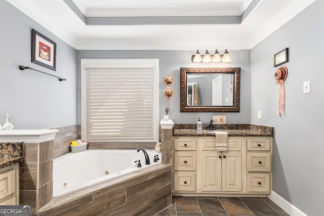 bathroom featuring vanity, tiled bath, a tray ceiling, and ornamental molding