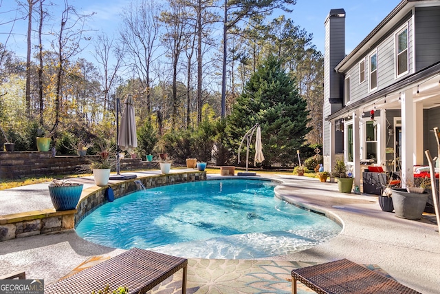 view of swimming pool featuring a patio area and pool water feature