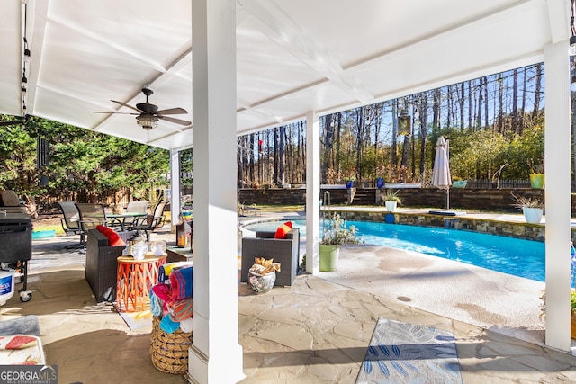 view of swimming pool featuring ceiling fan and a patio