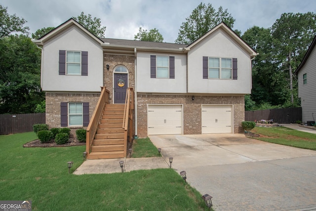 bi-level home with a front lawn and a garage