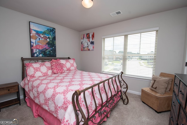 bedroom with light colored carpet