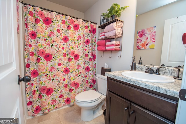 bathroom with vanity, toilet, and curtained shower