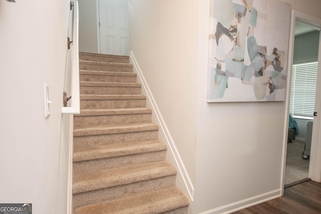 stairs featuring hardwood / wood-style floors