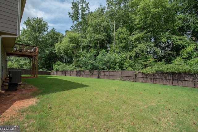 view of yard featuring cooling unit and a wooden deck